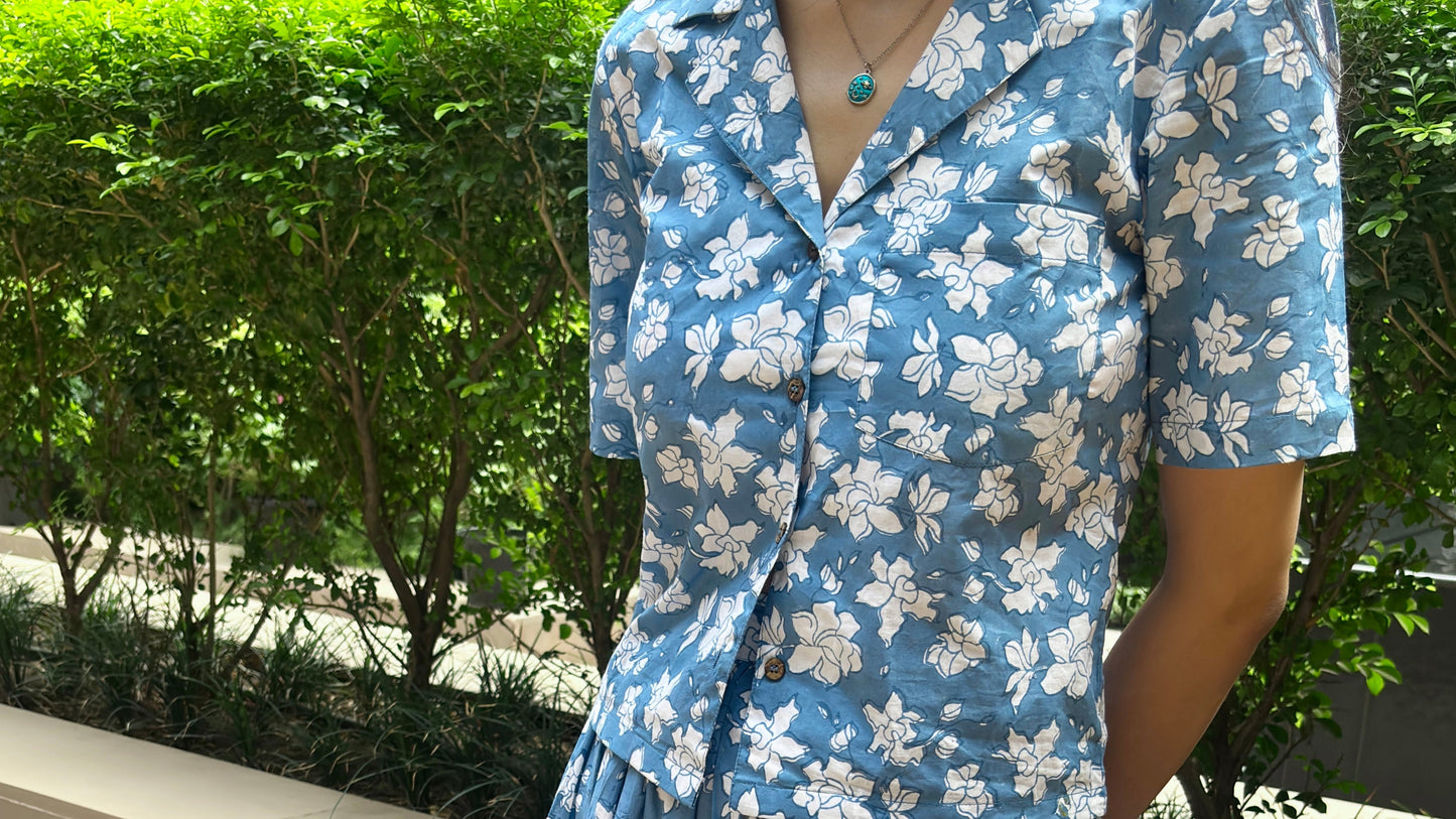 Woman wearing a blue floral coord set standing outdoors for summer style photoshoot.