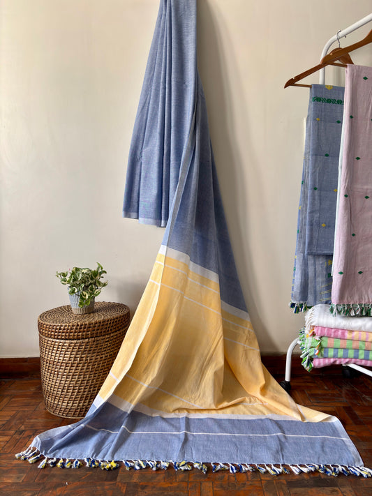 A handloom cotton saree with blue and yellow colours that flows and drapes easily.
