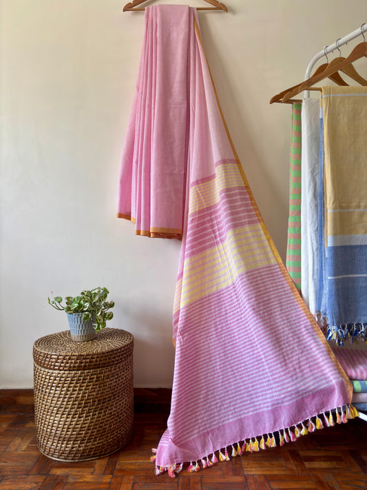 A handloom cotton saree in soft pink and yellow with a striped pattern on the pallu.